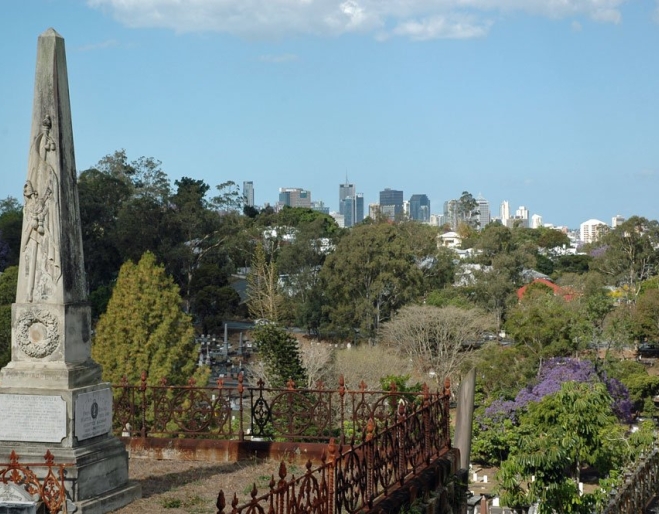Tomb stone with city views from top of hill in Toowong Cemetery.