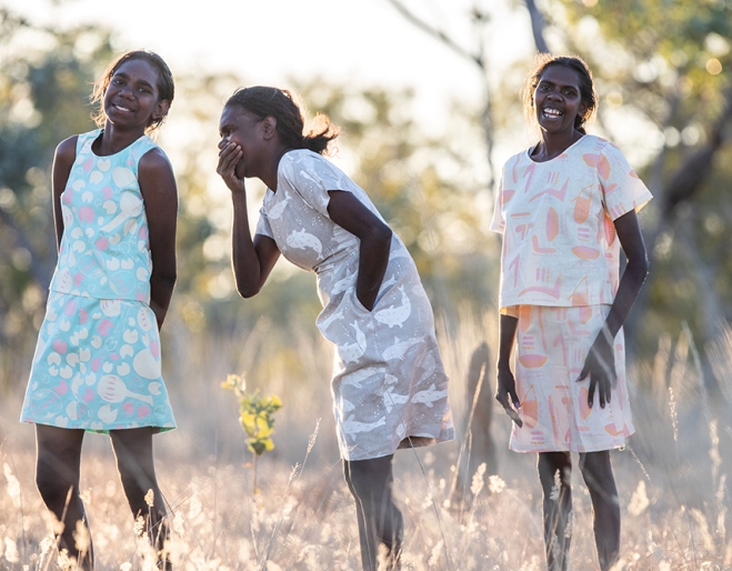 Three First Nations women wearing fashions by First Nations designers at Stories You Wear: Magpie Goose