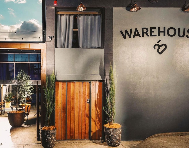 Exterior lit up facade of Warehouse 25, Milton