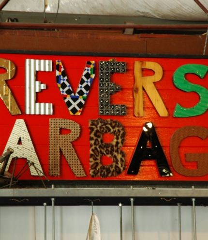 Reverse Garbage sign made out of recycled materials