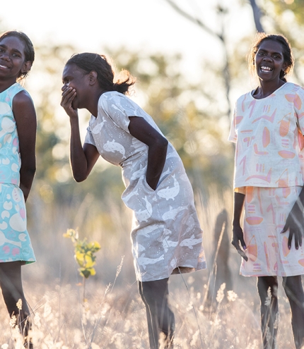 Three First Nations women wearing fashions by First Nations designers at Stories You Wear: Magpie Goose