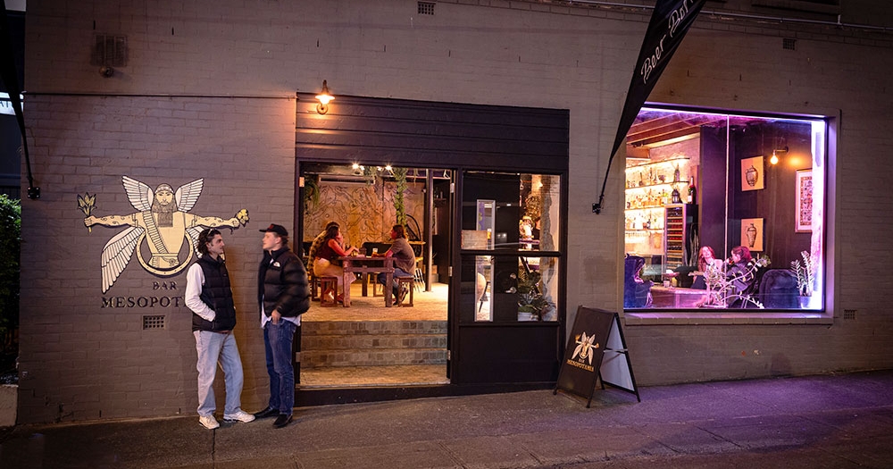 People outside Bar Mesopotamia by night