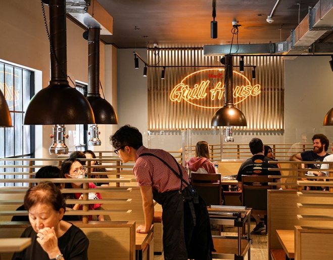 Wait staff talking with diners inside Maru Grill House Brisbane CBD