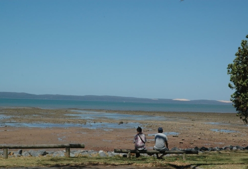 Couple sitting on bench in Harold Walker Park Cleveland looking at the ocean. 