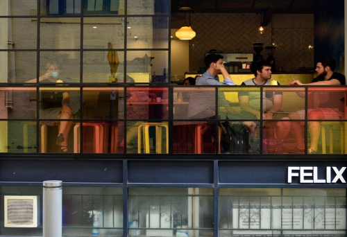 Felix Espresso  People sitting in Felix Espresso seen through coloured glass on Burnett Lane
